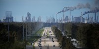 Traffic moves along a stretch of roads near the Royal Dutch Shell and Valero Energy's Norco refineries in LaPlace, La., in 2021.