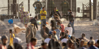Immigrants wait to be transported and processed by U.S. Border Patrol agents in El Paso, Texas