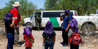 A U.S. Customs and Border Patrol agent arrives to pick up a family of five in the Tucson Sector of the U.S.-Mexico border
