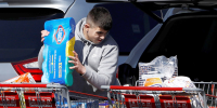 People load Clorox into their car in the Costco parking lot after the first confirmed case of coronavirus was announced in New York State, in the Brooklyn
