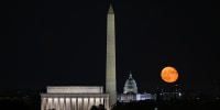 The moon rises over the Capitol