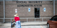 A woman walks to a Social Security office in Houston on July 13, 2022.