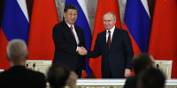 Russian President Vladimir Putin and China’s President Xi Jinping shake hands after delivering a joint statement following their talks at the Kremlin in Moscow