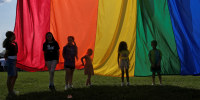 Children hold the rainbow flag during an LGBTQ Pride event in Franklin, Tenn., on June 3, 2023.   