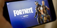 The Epic Games Inc. Fortnite: Battle Royale video game is displayed an iPhone.