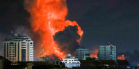 Image: A fireball erupts above Gaza City after an Israeli airstrike on Oct. 9.