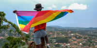 A gay man poses with a Pride flag  in Uganda on March 25, 2023. 