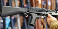 A bump stock device is installed on a AK-47 semi-automatic rifle, at a gun store in Salt Lake City