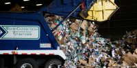 A truck offloads recycling at the Pasco County Resource Recovery Facility waste-to-energy plant in Spring Hill, Fla., on Oct. 25, 2023. 