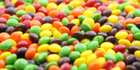 A closeup of a bowl of Skittles.