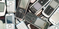 Different old phones piled and stacked on top of each other