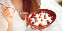 woman eats cottage cheese with berries