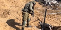 An IDF soldier looks down a tunnel allegedly used by Hamas militants in northern Gaza on a tour led by by the IDF.
