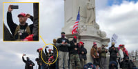 Edward Kelley at the Peace Monument across from the United States Capitol Building using a cell phone and wearing a red MAGA on Jan. 6, 2021.