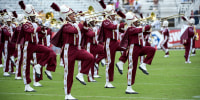 Alabama A&M marching band members play on a field.
