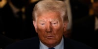 Light illuminates the top of Donald Trump's face as he stands outside court.