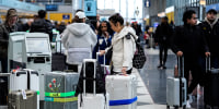 Image: Passengers check luggage in Terminal 1