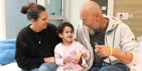Abigail Edan, who returned to Israel after being released by Hamas, with her aunt Liron and uncle Zuli at Schneider Children's Medical Center in Israel. Abigail's parents were both killed by Hamas militants in the same attack in which she was kidnapped.