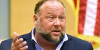 Alex Jones speaks on the witness stand at his Sandy Hook defamation damages trial