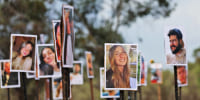 Pictures of victims of the Nova music festival attack are displayed at the site near Kibbutz Re'im and Israel's border with Gaza on Nov. 28, 2023.