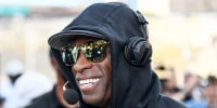 Head coach Deion Sanders gives a pregame interview before a game  in Boulder, Colo.