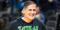 Mark Cuban on the court smiling prior to the start of an NBA basketball game.