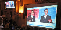 California Gov. Gavin Newsom and Florida Gov. Ron DeSantis debate on a screen during a watch party at Manny's on Nov. 30, 2023 in San Francisco.