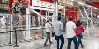People walk inside the Tesla gigafactory.