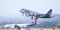 Alaska and Hawaiian Airlines planes takeoff at the same time from San Francisco International Airport in San Francisco, Calif. on June 21, 2023. 