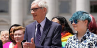 Evers with Aspen Morris at the raising of an LGBTQ flag  at the Capitol in Madison