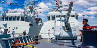 Two Chinese warships have made a first visit to a Cambodian naval base that Washington has long feared will boost Beijing's influence in the Gulf of Thailand. 