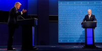 Donald Trump speaks during a debate as Joe Biden listens.