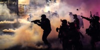 Federal officers deploy tear gas and less-lethal munitions while dispersing a crowd of about a thousand protesters in front of the Mark O. Hatfield U.S. Courthouse