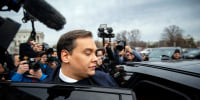 George Santos get into a car surrounded by media as leaves the Capitol.