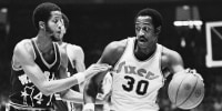 76ers forward George McGinnis, right, during a game in Philadelphia