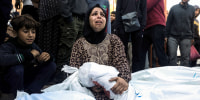 A mother hugs her one-year-old son who was killed during Israeli air strikes on Dec. 15, 2023 in Khan Yunis, Gaza.