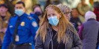 Passengers, with and without face masks, at Los Angeles International Airport on Jan. 10, 2024.