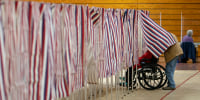 A voters leaves a booth after casting a ballot in the New Hampshire presidential primary at a poling site in Derry, N.H., Tuesday, Jan. 23, 2024. 