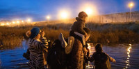 Migrants try to cross the Rio Grande River to the United States border