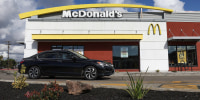 A car drives in front of a McDonald's restaurant on February 6, 2024, in San Leandro, Calif.