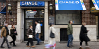 Pedestrians walk past a Chase bank branch in New York in 2023.