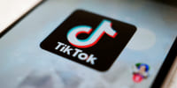 TikTok logo is displayed on a smartphone.