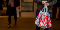 A shopper carries bags outside a Target store 