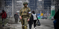 A Russian soldier patrols in a street of Mariupol