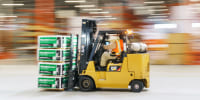 An employee operates a forklift inside a flatbed distribution center in Stonecrest, Ga
