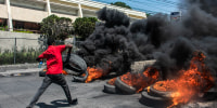 A protester burns tires during a demonstration