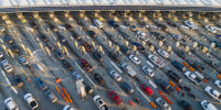  In an aerial view, morning commuter traffic waits to cross into the United States from Tijuana, Mexico on March 6, 2024 in San Ysidro, California. 