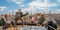 National Guard soldiers lay material out in preparation to build and repair damaged fencing on the banks of the Rio Grande river near Shelby Park on March 21, 2024 in Eagle Pass, Texas. 