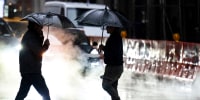 People walk through rain in midtown Manhattan 