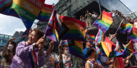Participants seen waving rainbow flags during the Bangkok